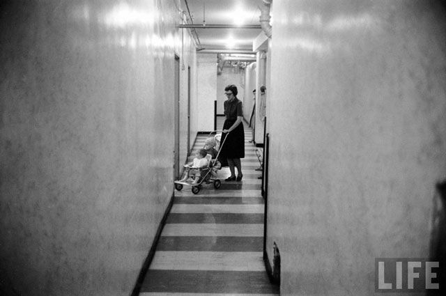 Phyllis Huntington w. her daughters in hallway of a LeFrak City apartment building. 1961
